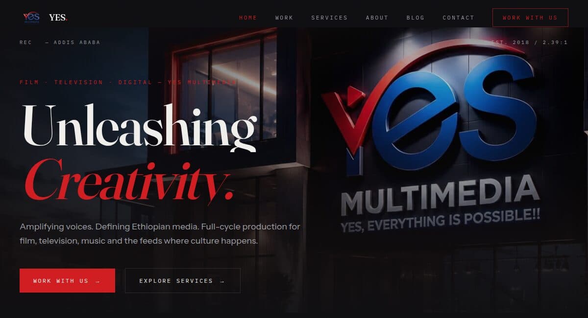 YES Multimedia homepage — dark cinematic hero reading Unleashing Creativity beside the studio's illuminated signage.